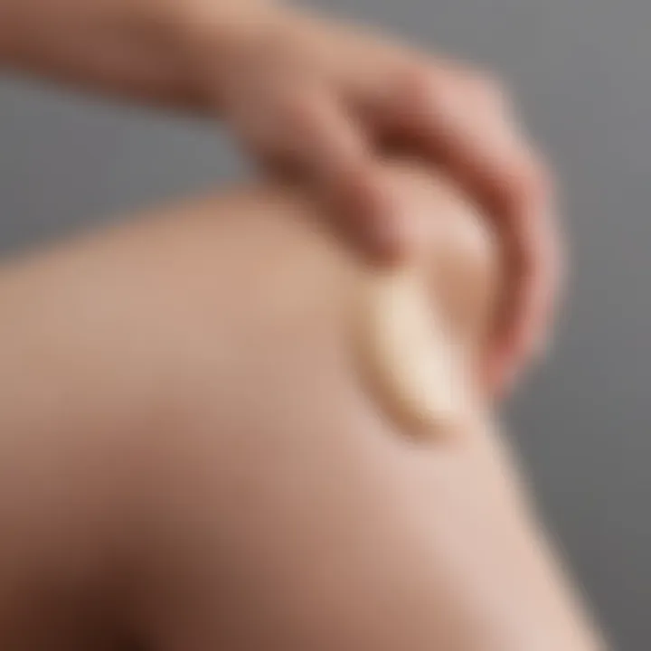 Close-up of a hand applying cream on the leg