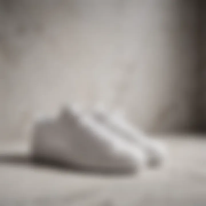 Minimalist White Leather Tennis Shoes on Marble Surface