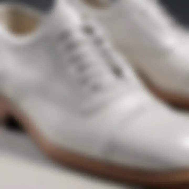 Close-up of intricate stitching details on white leather shoe