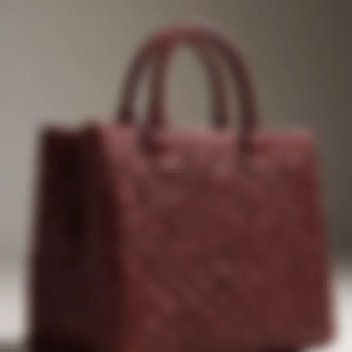 Intricately woven Staud handbag in rich burgundy