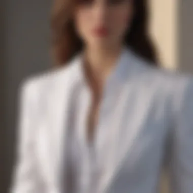 Structured white cotton blouse layered under a sleek blazer