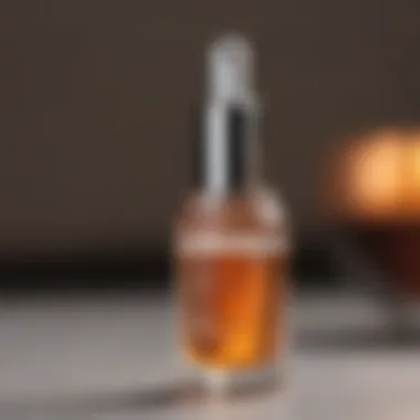 Close-up of Tan Luxe The Face serum dropper