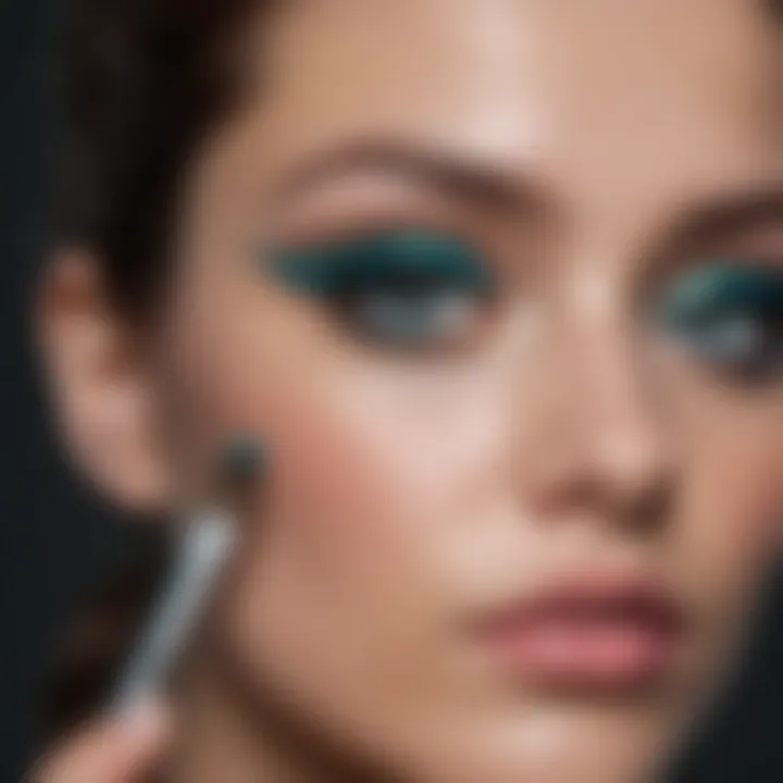 Teal eyeshadow brush applying a shimmery teal shade