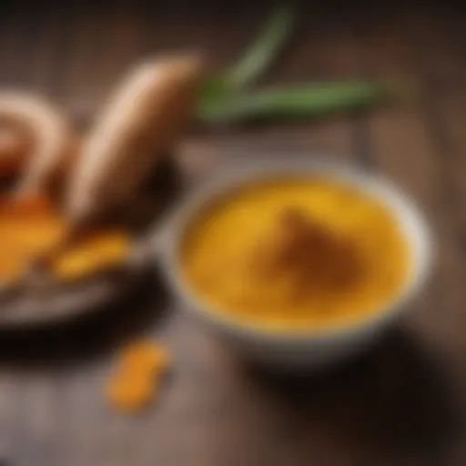 Golden turmeric powder in a bowl with fresh turmeric root on a wooden surface