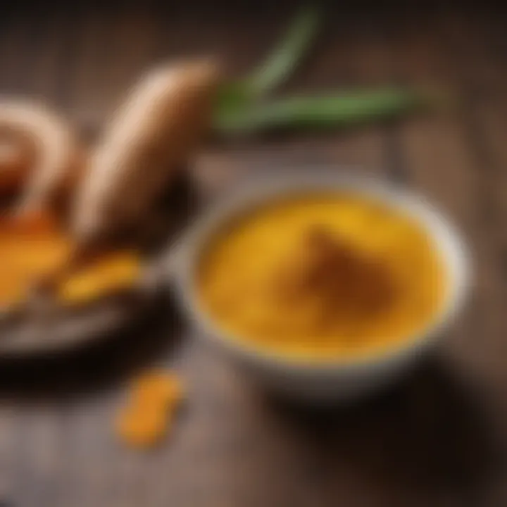 Golden turmeric powder in a bowl with fresh turmeric root on a wooden surface