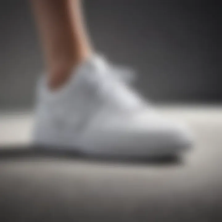 Elegant and supportive white tennis shoe with arch technology